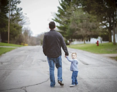 man-holding-his-inner-child-hand-while-walking