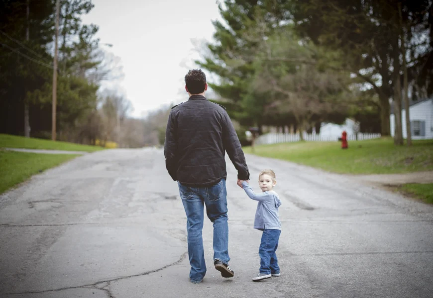 man-holding-his-inner-child-hand-while-walking