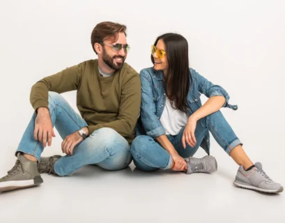 stylish-couple-sitting-on-floor-in-jeans