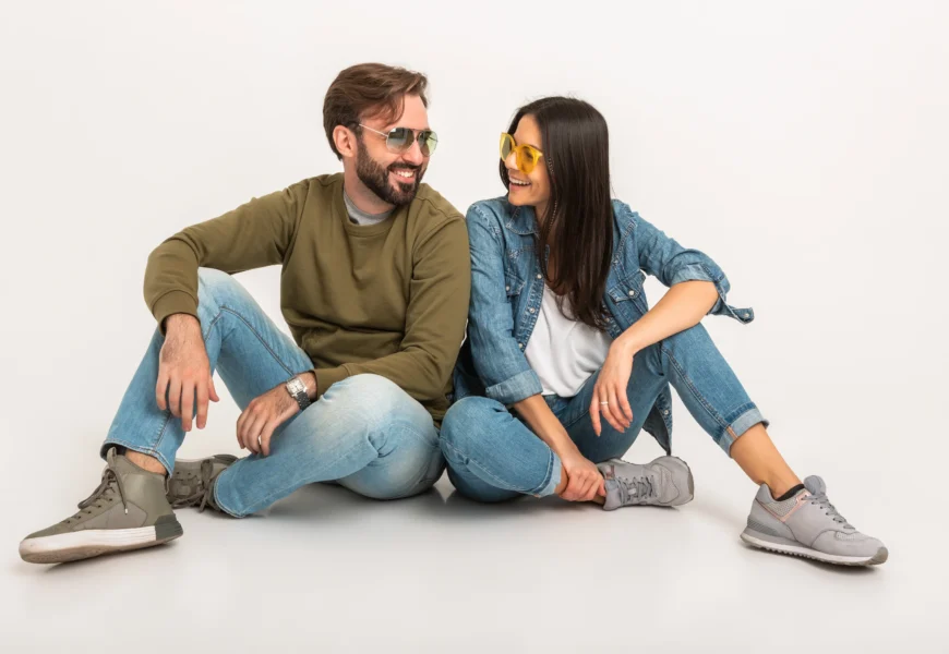 stylish-couple-sitting-on-floor-in-jeans