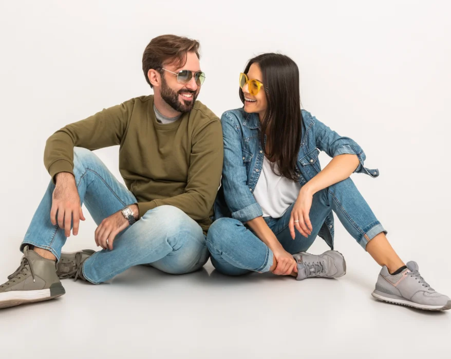 stylish-couple-sitting-on-floor-in-jeans