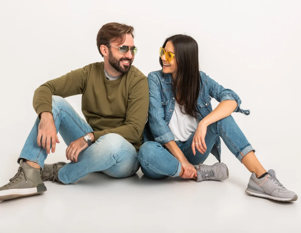 stylish-couple-sitting-on-floor-in-jeans