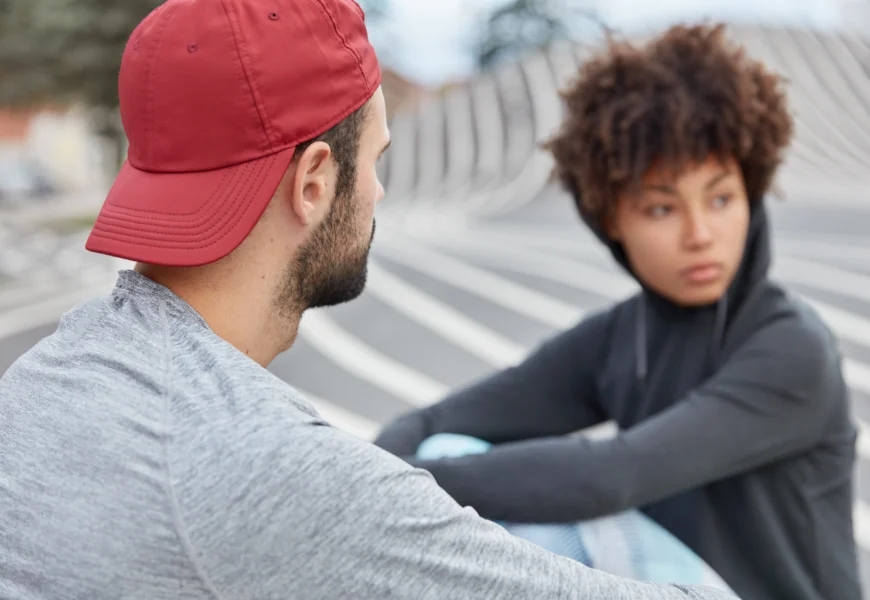 stylish-female-and-male-hipsters-sit-on-road-have